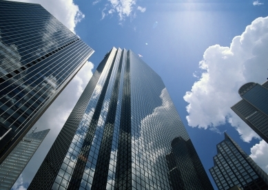 Office buildings reflecting clouds, low angle view